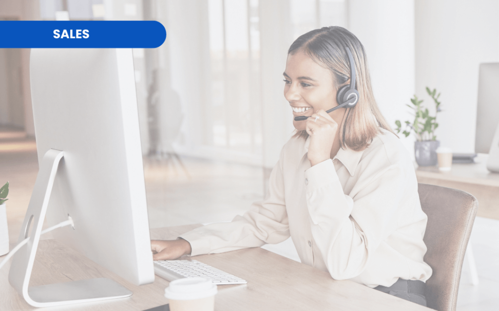 Woman on a sales call wearing a headset at her desk.